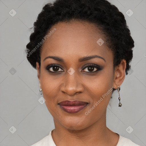 Joyful black young-adult female with short  black hair and brown eyes