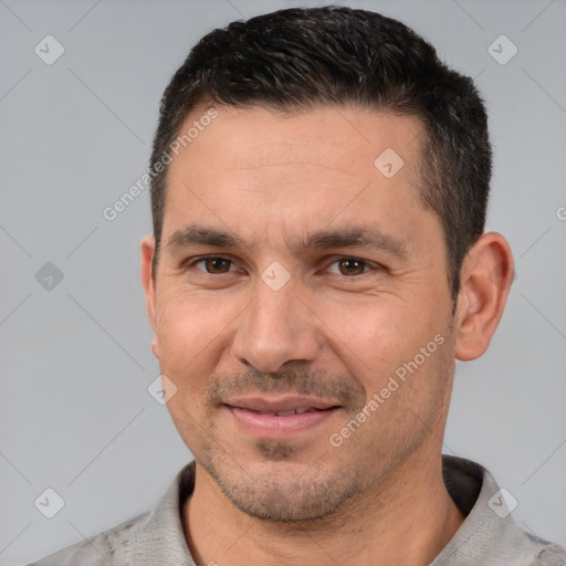 Joyful white adult male with short  black hair and brown eyes