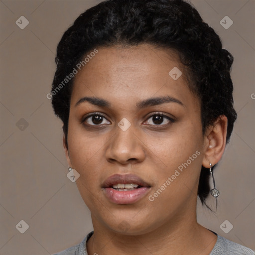 Joyful black young-adult female with short  black hair and brown eyes