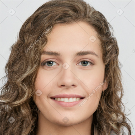 Joyful white young-adult female with long  brown hair and green eyes