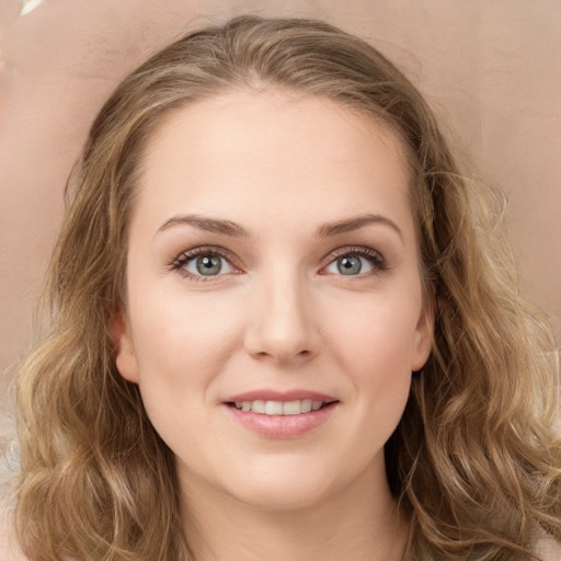 Joyful white young-adult female with long  brown hair and green eyes