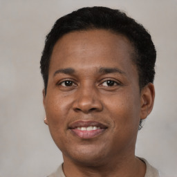 Joyful black adult male with short  brown hair and brown eyes
