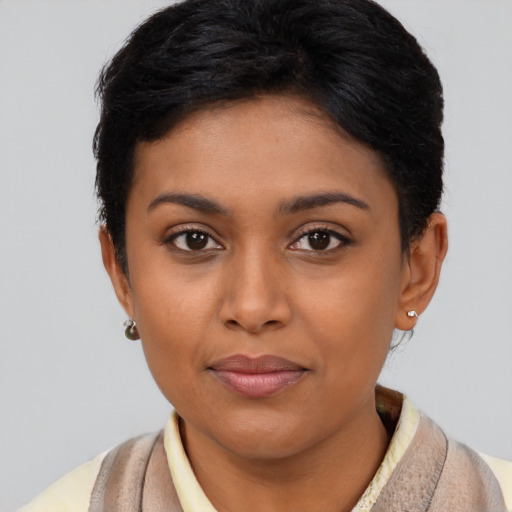 Joyful latino young-adult female with short  brown hair and brown eyes
