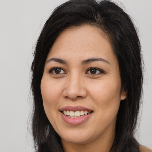 Joyful asian young-adult female with long  brown hair and brown eyes