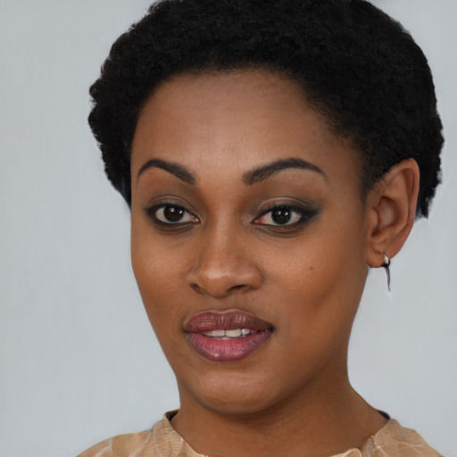 Joyful black young-adult female with short  black hair and brown eyes