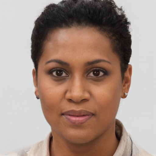 Joyful black young-adult female with short  brown hair and brown eyes