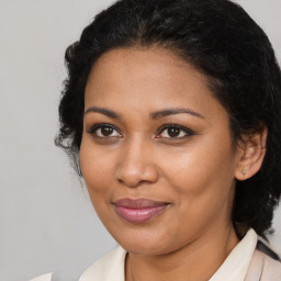 Joyful black young-adult female with medium  brown hair and brown eyes