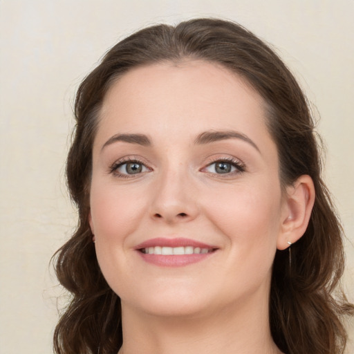 Joyful white young-adult female with long  brown hair and grey eyes