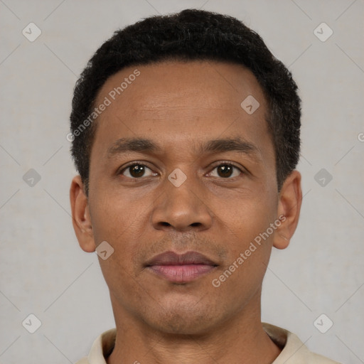 Joyful latino young-adult male with short  brown hair and brown eyes