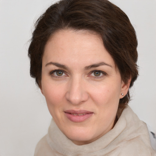 Joyful white young-adult female with medium  brown hair and green eyes