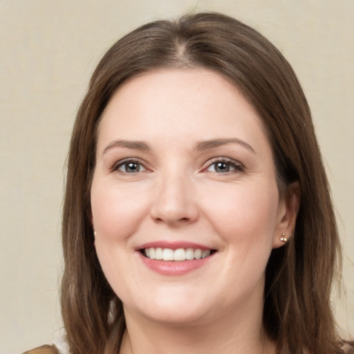 Joyful white young-adult female with long  brown hair and grey eyes