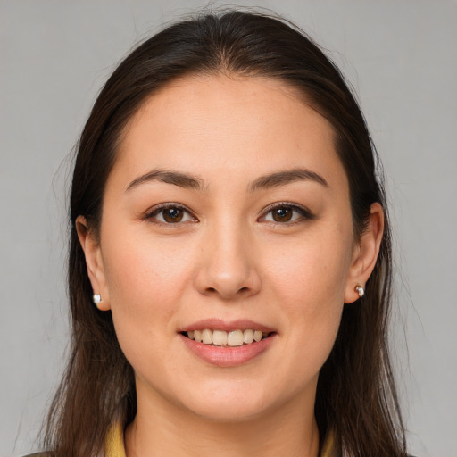 Joyful white young-adult female with long  brown hair and brown eyes