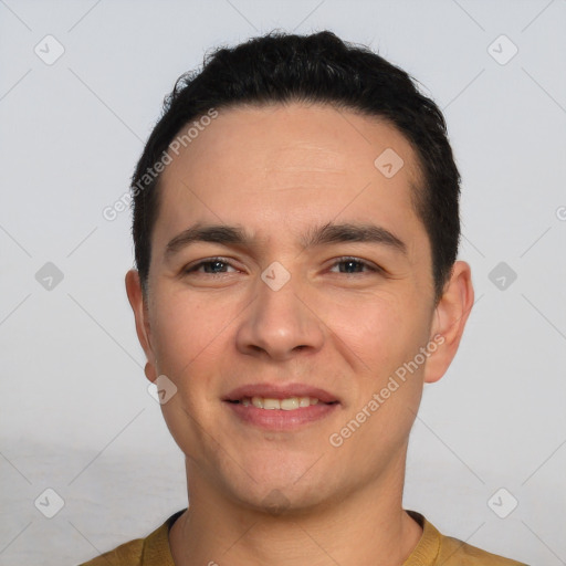 Joyful white young-adult male with short  black hair and brown eyes