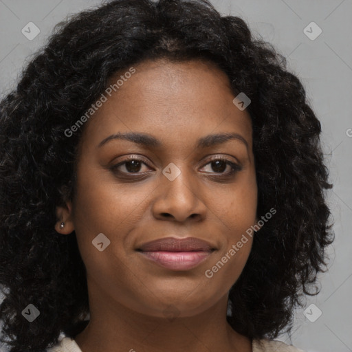 Joyful black young-adult female with long  brown hair and brown eyes