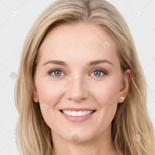 Joyful white young-adult female with long  brown hair and blue eyes