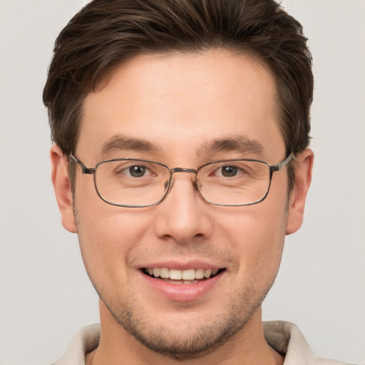 Joyful white young-adult male with short  brown hair and brown eyes