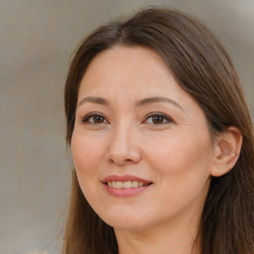 Joyful white adult female with long  brown hair and brown eyes
