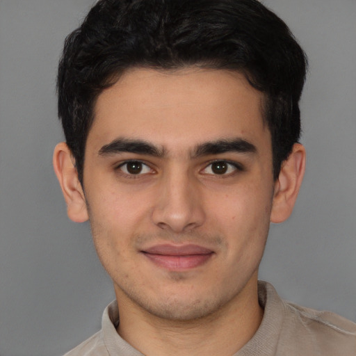 Joyful latino young-adult male with short  brown hair and brown eyes