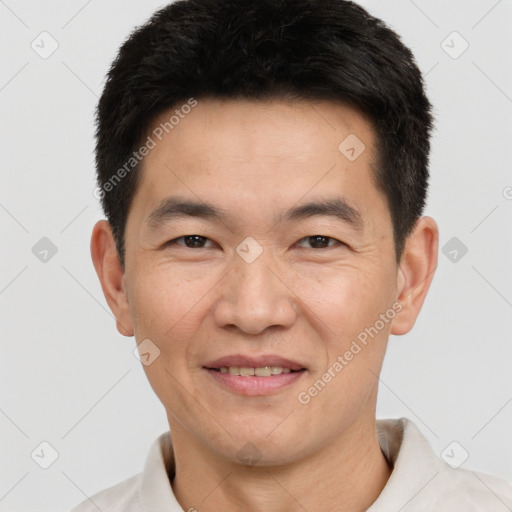 Joyful white adult male with short  black hair and brown eyes