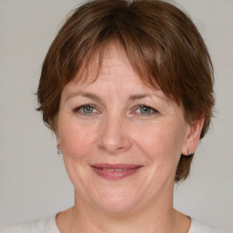 Joyful white adult female with medium  brown hair and grey eyes