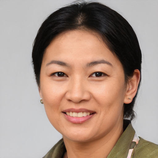 Joyful asian adult female with medium  brown hair and brown eyes