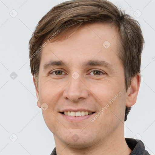 Joyful white young-adult male with short  brown hair and grey eyes