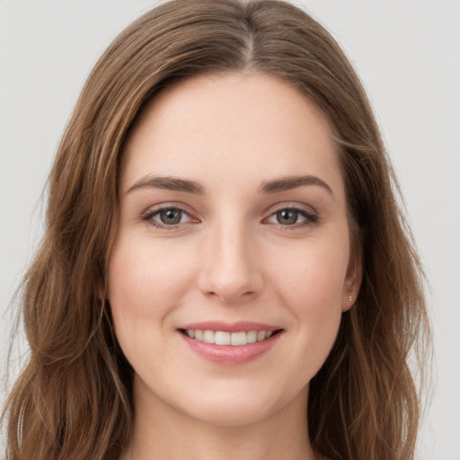 Joyful white young-adult female with long  brown hair and grey eyes