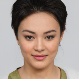 Joyful asian young-adult female with medium  brown hair and brown eyes