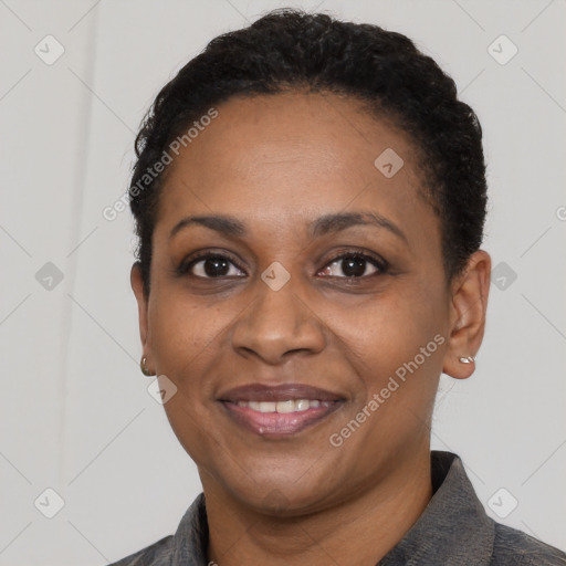 Joyful black adult female with short  black hair and brown eyes