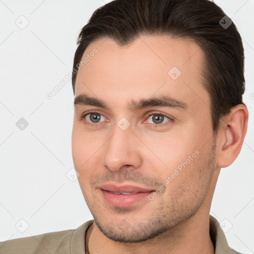 Joyful white young-adult male with short  brown hair and brown eyes