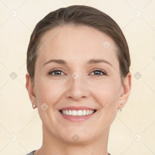 Joyful white young-adult female with short  brown hair and brown eyes