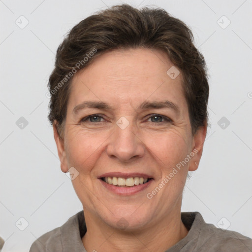 Joyful white adult female with short  brown hair and grey eyes