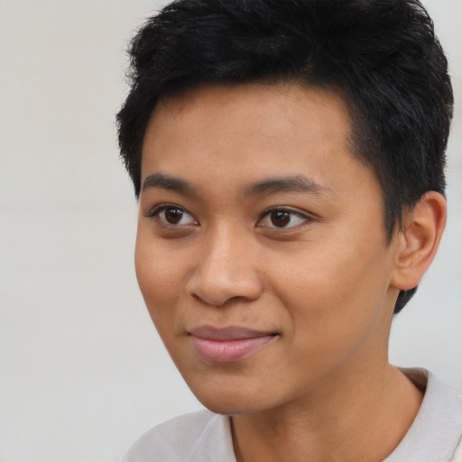 Joyful asian young-adult female with short  black hair and brown eyes