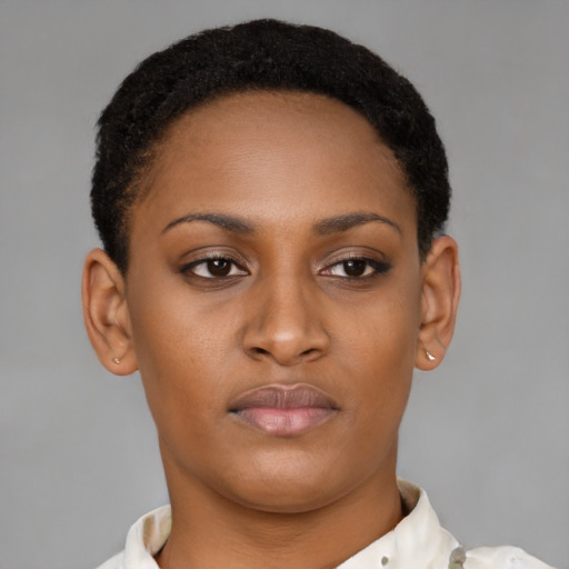 Joyful black young-adult female with short  brown hair and brown eyes