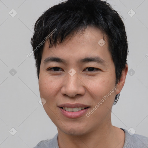 Joyful asian young-adult male with short  black hair and brown eyes