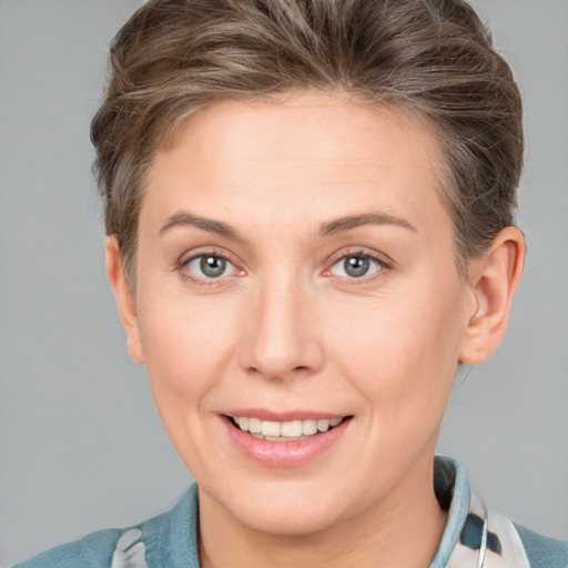 Joyful white young-adult female with short  brown hair and grey eyes