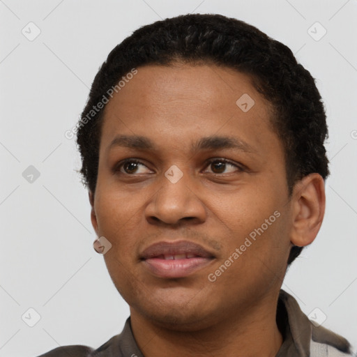 Joyful black young-adult male with short  black hair and brown eyes