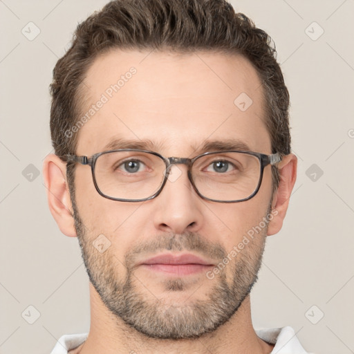 Joyful white adult male with short  brown hair and brown eyes