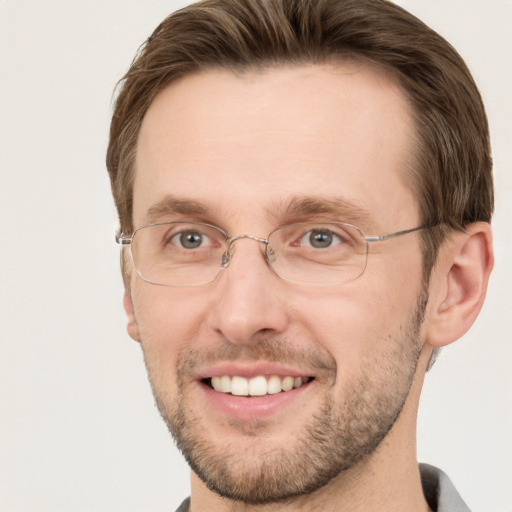 Joyful white adult male with short  brown hair and grey eyes