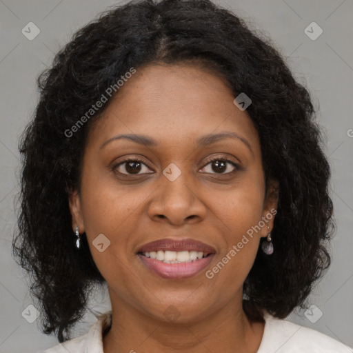 Joyful black adult female with medium  brown hair and brown eyes