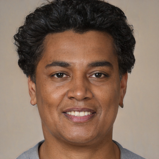 Joyful latino young-adult male with short  brown hair and brown eyes