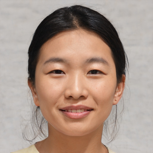 Joyful asian young-adult female with medium  black hair and brown eyes