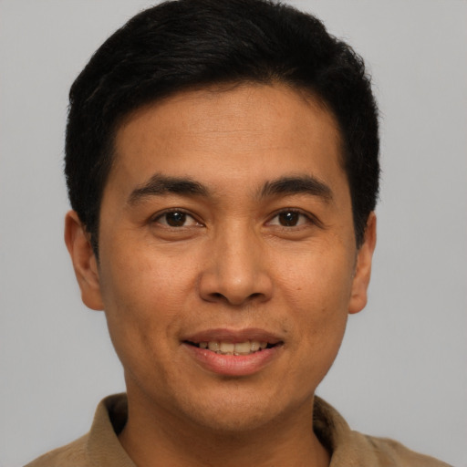 Joyful asian young-adult male with short  brown hair and brown eyes