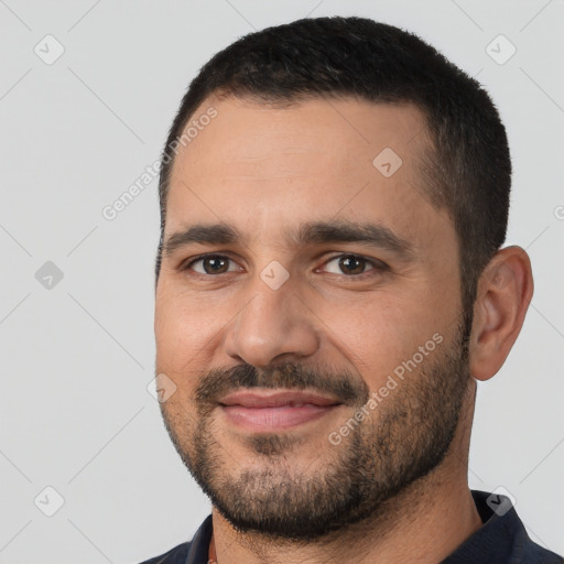 Joyful white adult male with short  black hair and brown eyes