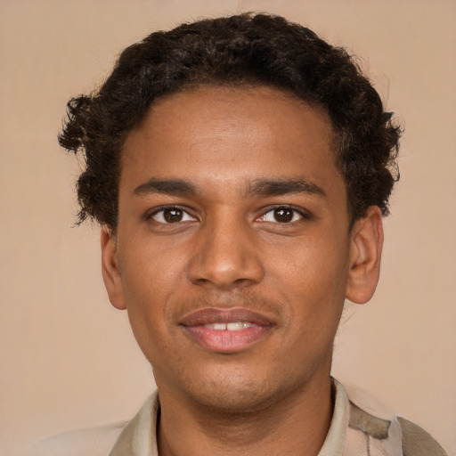 Joyful black young-adult male with short  brown hair and brown eyes