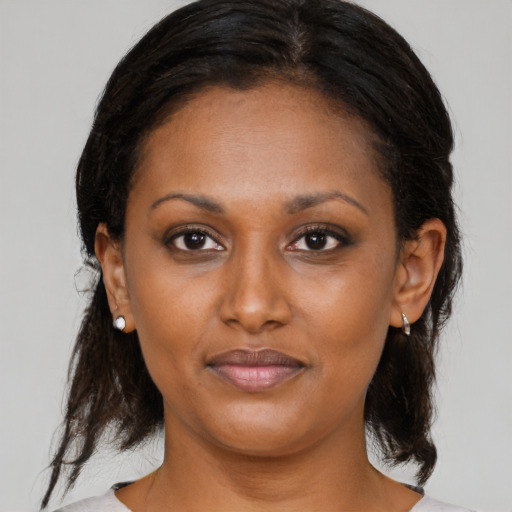Joyful black young-adult female with medium  brown hair and brown eyes