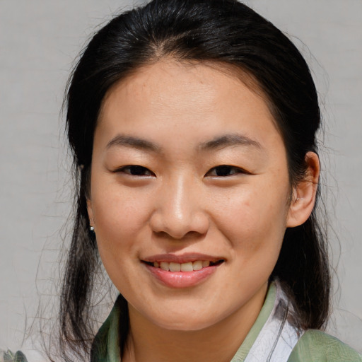 Joyful asian young-adult female with medium  brown hair and brown eyes