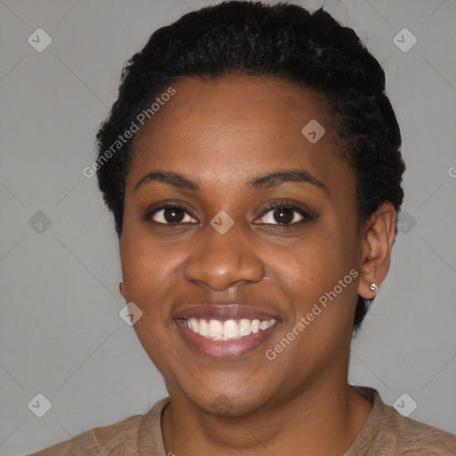 Joyful black young-adult female with short  black hair and brown eyes