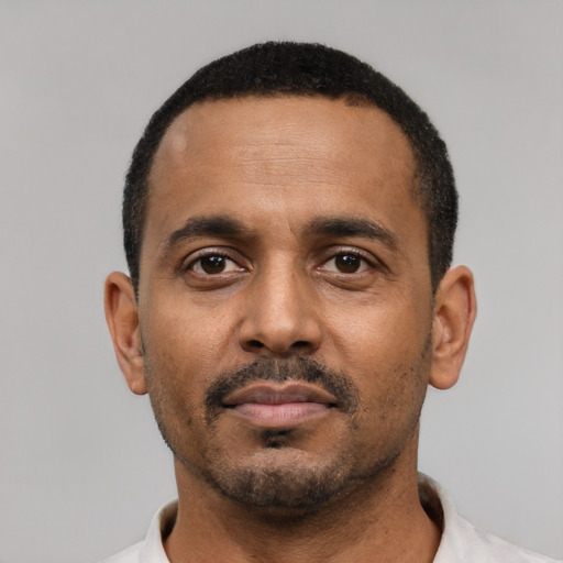 Neutral black young-adult male with short  black hair and brown eyes
