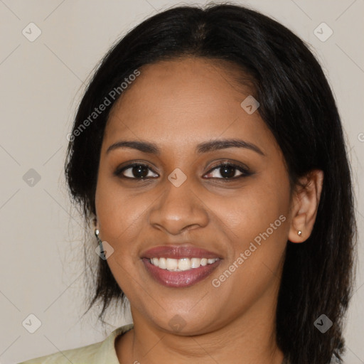 Joyful black young-adult female with long  black hair and brown eyes